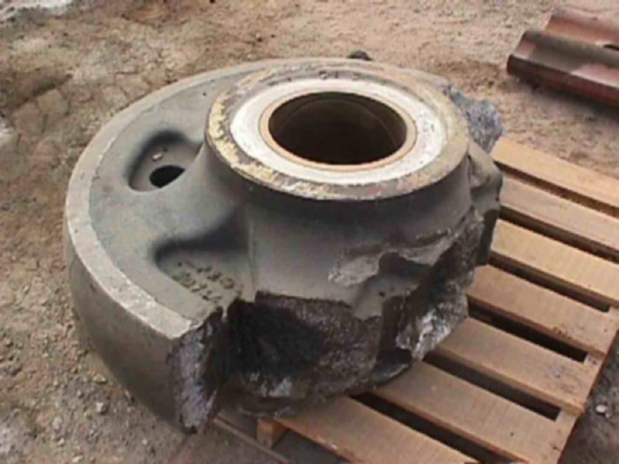 Cast OEM rear idler, fractured in service. The fix: forged 4340 steel — zero failures in 25 years of supply.